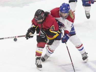 Calgary Inferno's Brigette Lacquette (left) battles for the puck with Les Canadiennes de Montreal's Lauriane Rougeau during second period action in the 2019 Clarkson Cup game in Toronto, on Sunday, March 24, 2019.