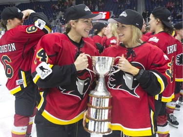 Calgary Inferno's Zoe Hickel (left) and Tori Hickel celebrate with the trophy after beating Les Canadiennes de Montreal 5-2 to win the 2019 Clarkson Cup game in Toronto, on Sunday, March 24 , 2019.