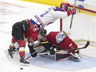 Les Canadiennes de Montreal's Hilary Knight collides with the Calgary goal under a challenge from Calgary Inferno's Kacey Bellamy and goaltender Alex Rigsby before Jill Saulnier's disallowed goal, during third period action in the 2019 Clarkson Cup game in Toronto, on Sunday, March 24 , 2019.