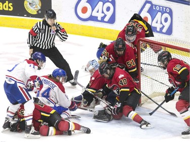 Calgary Inferno's defence smother the puck under pressure from Les Canadiennes de Montreal's Erin Ambrose and Jill Saulnier during third period action in the 2019 Clarkson Cup game in Toronto, on Sunday, March 24 , 2019.