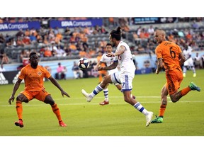 Montreal Impact's Maximiliano Urruti, passes the ball past Houston Dynamo's Maynor Figueroa on Saturday, March 9, 2019, in Houston.