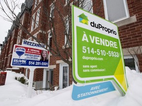 For-sale signs are seen in front of a Montreal condominium in 2015.