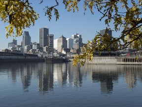 The City of Montreal is reflected in the St. Lawrence River, Tuesday, November 10, 2015. "Canada is not immune to the water issues now threatening so many parts of the world. It is past time we stopped taking our water for granted," Maude Barlow and Alice-Anne Simard write.