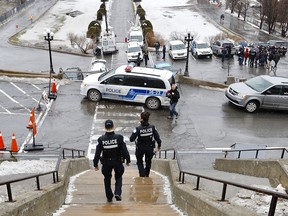 Montreal police officers at the scene of a stabbing at St. Joseph's Oratory March 22, 2019. Father Claude Grou was hospitalized and returned to saying mass a week later.