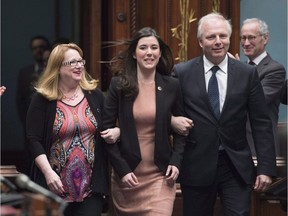 Newly-elected member of the legislature for Marie-Victorin, Catherine Fournier, centre, is escorted to her seat by Parti Quebecois Leader Jean-Francois Lisee, right, and party whip Carole Poirier, as the legislature resumes for its spring session, Tuesday, February 7, 2017 at the legislature in Quebec City. Fournier, a 26-year-old lauded as the future of the PQ, quit Monday to sit as an independent.