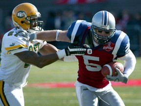 Eric Lapointe of the Alouettes tries to elude Edmonton Eskimos tackler Donny Brady during the third quarter at Molson Stadium in Montreal on Oct. 5, 2003.