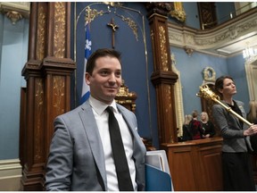 Quebec Minister of Immigration, Diversity and Inclusiveness Simon Jolin-Barrette walks in to table a bill on laicity of the state, Thursday, March 28, 2019 at the legislature in Quebec City. After the bill was presented, the National Assembly unanimously voted to have the crucifix removed.