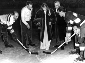This photo from our archives shows Scott ceremonially dropping the puck. Bill O'Brien of the Sages (right) and Gérard Pauzé of the Hobos were all ready to go. Behind, in the suit, is Verdun Mayor Edward Wilson. The referee (in the sweater), André Montpetit, was a prominent lawyer.