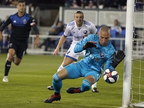 Montreal Impact goalkeeper Evan Bush blocks a shot on goal by the San Jose Earthquakes during the first half of an MLS soccer match in San Jose, Calif., on March 2, 2019. Given the Impact's continued struggles on the road, goalkeeper Bush wanted to give his side a leg up — so he probed the opposition.