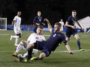 University of Maryland's Amar Sejdic (10) and Akron's Cario Ritaccio collide as they go for the ball during the 2018 NCAA College Cup soccer match at the University California in Santa Barbara, Calif., Sunday, Dec. 9, 2018. The Montreal Impact has signed midfielder Amar Sejdic to a one-year contract with three option years.