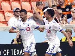 Montreal Impact's Saphir Taider (8) celebrates with Daniel Lovitz (3) after scoring a goal against the Houston Dynamo during the first half of an MLS soccer match Saturday, March 9, 2019, in Houston.