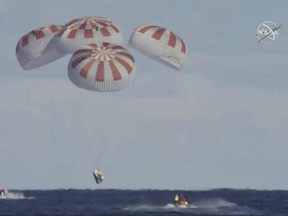 This image provided by NASA shows SpaceX's Dragon capsule carrying a test dummy splashed down into the Atlantic Ocean off the Florida coast on Friday, March 8, 2019.