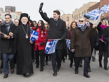 Prime Minister Justin Trudeau, centre, waves to the crowd as he attends the annual Greek Independence Day Parade in Montreal, Sunday, March 24, 2019.