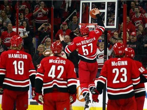 Carolina Hurricanes' Trevor van Riemsdyk (57) dunks a basketball during a celebration after the team's win over the Minnesota Wild on Saturday. The Canadiens are hoping they won't have to see another such celebration after their game in Raleigh on Sunday.