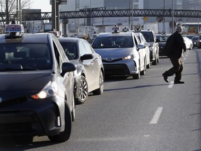 Taxi drivers bring Cote-de-Liesse to a halt during a strike by taxi drivers as they protest new legislation deregulating parts of the taxi industry March 25, 2019.