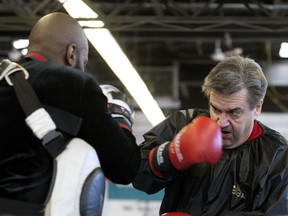 Former mayor Denis Coderre works out with Ali Nestor at the former pro fighter's gym in St-Michel.