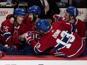 Canadiens' Ryan Poehling is congratulated by Phillip Danault, Max Domi and Brendan Gallagher after scoring a hat trick against the Toronto Maple Leafs  in Montreal on Saturday, April 6, 2019.