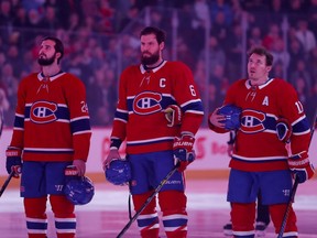 Montreal Canadiens centre Phillip Danault, from left, defenceman Shea Weber and right-winger Brendan Gallagher stand for the national anthem ahead of game against the Toronto Maple Leafs in Montreal on April 6, 2019.