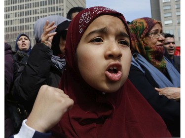 A youngster pumps her fist in protest at Place Émilie-Gamelin in Montreal on Sunday, April 7, 2019, at a demonstration to denounce the Quebec government's Bill 21.