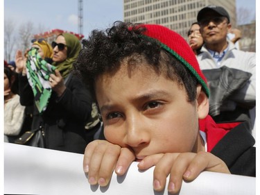 A youngster listens to speakers at Place Émilie-Gamelin in Montreal on Sunday, April 7, 2019, at a demonstration to denounce the Quebec government's Bill 21.