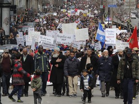 Thousands march on Rene Lévesque Blvd. in Montreal Sunday, April 7, 2019 to denounce the Quebec government's Bill 21. The Canadian Collective Anti- Islamophobia (CCAI) called for people to come out to protest the CAQ government's secularism bill which they say is "... discriminatory and undermines the fundamental rights of religious minorities in Quebec, particularly Muslim women wearing the hijab."