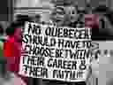 A woman holds a sign in Montreal Sunday, April 7, 2019 at a demonstration to denounce the Quebec government's Bill 21.