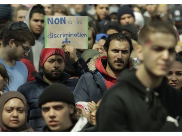 A man holds a sign in Place Émilie-Gamelin in Montreal on Sunday, April 7, 2019, to denounce the Quebec government's Bill 21.