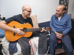 Henri Padron, right, listens to his brother Gabriel Sedes in his room at their home in the St-Laurent. Sedes is a student at the Galileo Adult Education Centre, which the EMSB is proposing to move about four kilometres away from its current location in Montreal North.