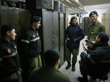 Army cadets, clockwise from bottom: Luke Bedros, Phillip Bedros, Mark Bedros, Yahya Alshami, Kevin Wu and Shiwon Choi talk in a locker room area after training exercises at the Royal Montreal Regiment in Westmount.