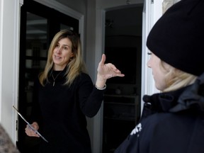 Sophie Sabourin greets police, firefighters and city officials at her Bouchard St. home. "I look at the river every day," she says.