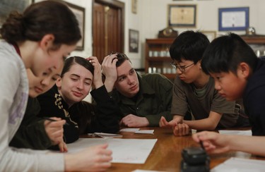 Cadets, from the left: Julia Tsukerman, Jennifer Lee, Amanda Hernandez Dzisiak, Matisse Ferland, Kevin Gao and Liu Rui work on making a map after an orienteering session outside at the Royal Montreal Regiment in Westmount.