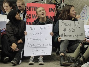 CEGEP and university students protest against Bill 21 outside the Quebec immigration office on Notre Dame St. Friday, April 12, 2019 in Montreal. Bill 21 would impose a ban on public employees in positions of authority from wearing symbols of faith. These would include police officers, teachers and judges.