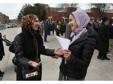 Ghadir  Kazzaz and Judith Levine share a laugh at a Rally For Religious Freedom and against the CAQ government's Bill 21 in Côte-St-Luc on Sunday, April 14, 2019.