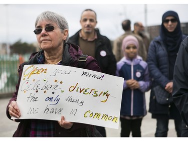 A woman holds a sign as she and others  listen to speakers at a Rally For Religious Freedom and against the CAQ government's Bill 21 in Côte-St-Luc on Sunday, April 14, 2019.