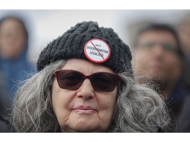 A woman listens to speakers at a Rally For Religious Freedom and against the CAQ government's Bill 21 in Côte-St-Luc on Sunday, April 14, 2019.