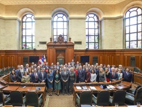 Members of city council posed for a group photo Monday afternoon to commemorate the last time they would meet in the elegant council chamber for three years.