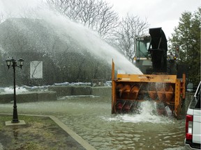 A snowblower propels water back toward the Rivière des Prairies in the Ste-Geneviève area of Montreal Saturday, April 27, 2019.