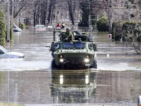 Soldiers patrol the flood zone in Ste-Marthe-sur-le-Lac on Monday April 29, 2019.