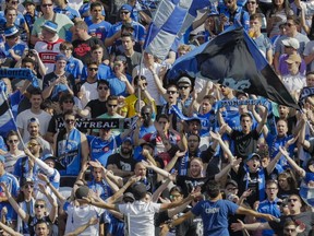 Montreal Impact fans cheer during the first half of the MLS soccer match against New York City FC at Saputo Stadium in Montreal on July 17, 2016.