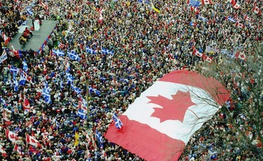 A huge Canadian flag marks a rally in support of Canadian unity days before the 1995 Quebec referendum.    (MONTREAL, QUE.: OCTOBER 27, 1995 --   AN OVERSIZE MAPLE LEAF FLAG MARKS A RALLY THAT DREW HUGE CROWDS TO PLACE DU CANADA IN SUPPORT OF CANADIAN UNITY ON OCT. 27, 1995, THREE DAYS BEFORE QUEBECERS VOTED IN THE REFERENDUM. (GORDON BECK/MONTREAL  GAZETTE)   For Mark Kennedy (Postmedia News).  POLL-QUEBEC) ORG XMIT: POS2012112815094699