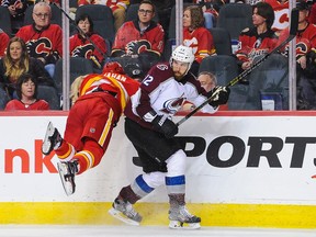 Sean Monahan #23 of the Calgary Flames misses a check on Patrik Nemeth #12 of the Colorado Avalanche in Game Five of the Western Conference First Round during the 2019 NHL Stanley Cup Playoffs at Scotiabank Saddledome on April 19, 2019 in Calgary, Alberta, Canada.