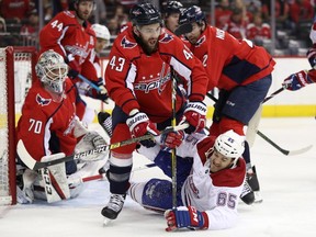 WASHINGTON, DC - APRIL 04: Andrew Shaw #65 of the Montreal Canadiens battles Tom Wilson #43 of the Washington Capitals for the puck during the first period at Capital One Arena on April 04, 2019 in Washington, DC.