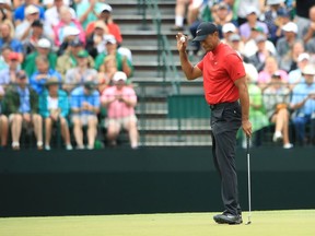 Tiger Woods of the United States waves after making a birdie on the 15th hole during the final round of the Masters at Augusta National Golf Club on Sunday, April 14, 2019, in Augusta, Ga.
