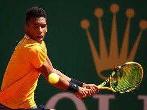 Felix Auger-Aliassime of Canada plays a backhand against Alexander Zverev of Germany  in their second round match during day four of the Rolex Monte-Carlo Masters at Monte-Carlo Country Club on April 17, 2019 in Monte-Carlo, Monaco.