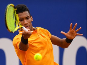 Felix Auger-Aliassime of Canada plays a forehand hand against Kei Nishikori of Japan during the round of 16 match on day two of the Barcelona Open Banc Sabadell at Real Club De Tenis Barcelona on April 25, 2019 in Barcelona, Spain.