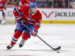 Canadiens' Phillip Danault carries the puck past centre ice against the Boston Bruins in Montreal on Dec. 17, 2018.
