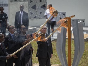 From left to right, Chairperson of the African Union Commission Moussa Faki Mahamat, Rwanda's President Paul Kagame, Rwanda's First Lady Jeannette Kagame, and President of the European Commission Jean-Claude Juncker, light the flame of remembrance at the Kigali Genocide Memorial in Kigali, Rwanda, Sunday, April 7, 2019. Rwanda is commemorating the 25th anniversary of when the country descended into an orgy of violence in which some 800,000 Tutsis and moderate Hutus were massacred by the majority Hutu population over a 100-day period in what was the worst genocide in recent history.