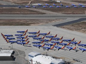 Southwest Airlines Boeing 737 MAX aircraft (foreground) are parked on the tarmac after being grounded, at the Southern California Logistics Airport in Victorville, California on March 28, 2019. - After two fatal crashes in five months, Boeing is trying hard -- very hard -- to present itself as unfazed by the crisis that surrounds the company. The company's sprawling factory in Renton, Washington is a hive of activity on this sunny Wednesday, March 28, 2019, during a tightly-managed media tour as Boeing tries to communicate confidence that it has nothing to hide. Boeing gathered hundreds of pilots and reporters to unveil the changes to the MCAS stall prevention system, which has been implicated in the crashes in Ethiopia and Indonesia, as part of a charm offensive to restore the company's reputation.