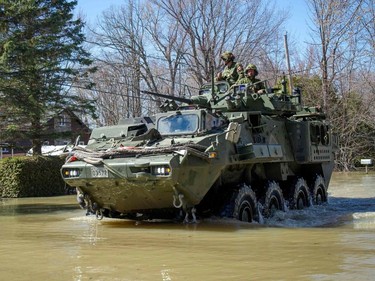 The Canadian Armed Forces navigate flood waters in Rigaud in the suburbs of Montreal, Quebec, Canada on Monday, April 22, 2019. - Flooding in eastern Canada has forced the evacuation of 1,200 people while more than 600 troops have been deployed in response, authorities said Sunday, April 21, 2019. Warming weather over the Easter weekend has brought spring floods due to heavy rains and snowmelt from Ontario to southern Quebec and New Brunswick.