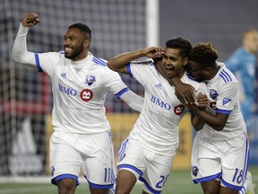 Montreal Impact's Anthony Jackson-Hamel (11) and Orji Okwonkwo (18) celebrate a goal by Shamit Shome (28) during the second half against the New England Revolution on April 24, 2019, in Foxborough, Mass.
